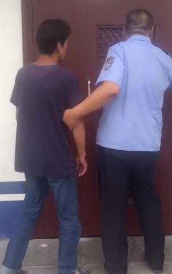 嫌犯顧某（左）遭警方逮捕。