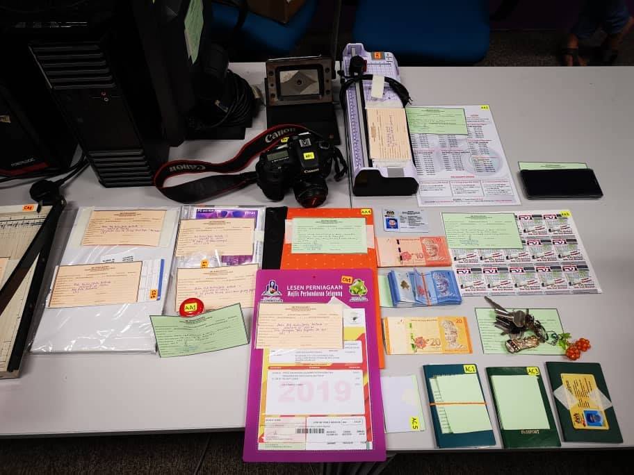 移民局在突击行动中起获伪造的外劳身分证名文件和相关器材。