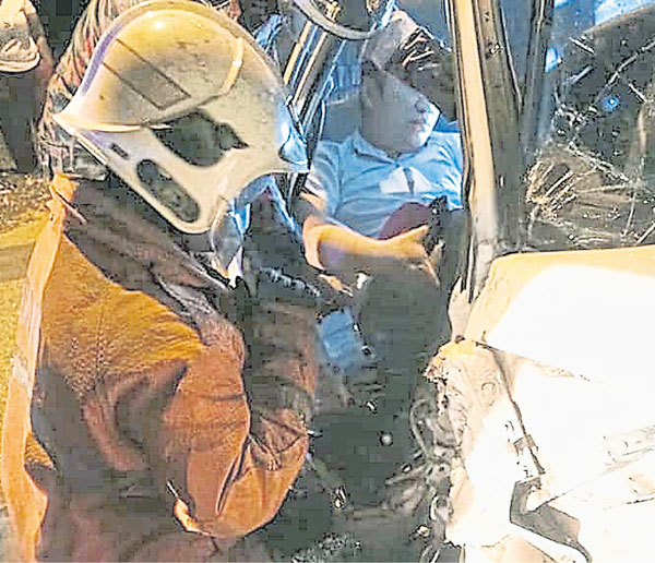 消拯员出动特别器具和九牛二虎之力，才把夹在司机座位的华裔男子救出。