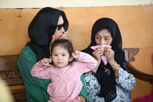 西蒂哈丝玛（右起）按捺不住流泪时，使用法拉莎扎哇妮（左起）2岁大女儿所递上毛巾擦眼泪。