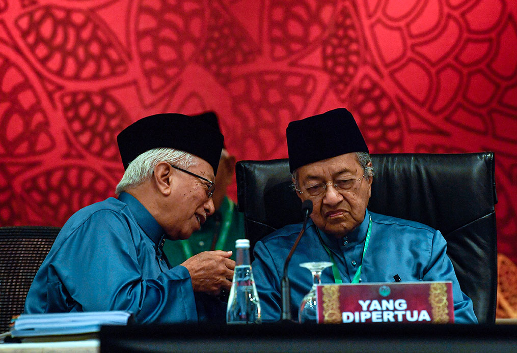 马哈迪（右）在大会上与马来西亚穆斯林福利组织总秘书丹斯里莫哈末尤索夫交流。
