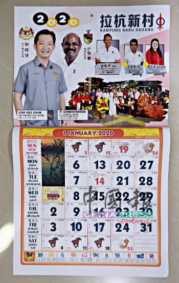 谢琪清到拉杭新村派发印有P古拿肖像的月历。