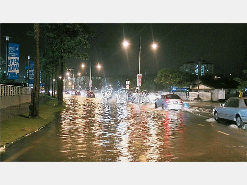 發林天德園大道也淹水，車子皆駛向最右邊沒淹水的路面行駛。