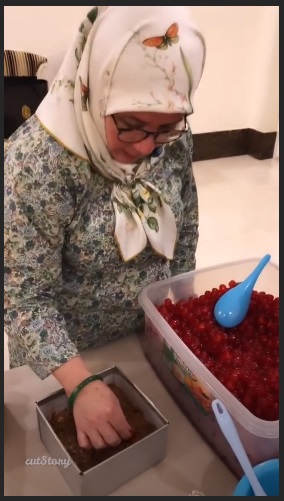 元首后东姑阿兹札用心地把樱桃装饰在蛋糕上。