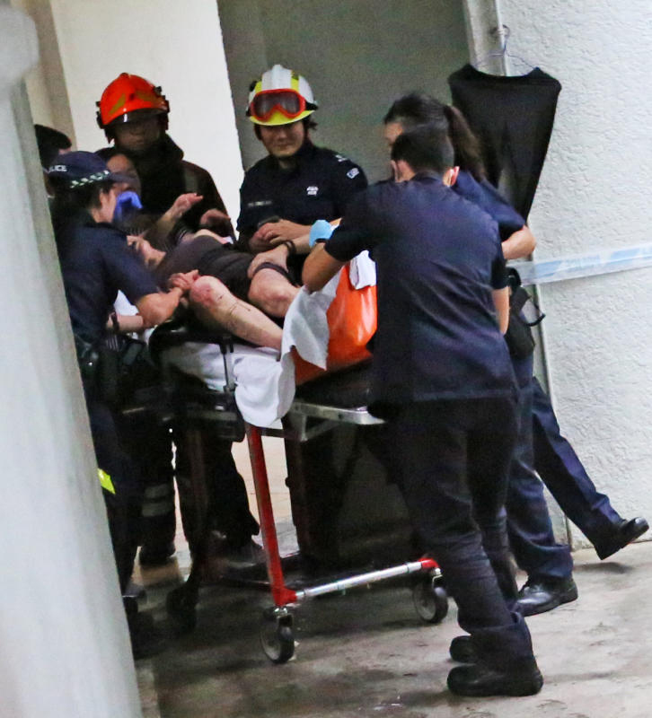 婦女被擔架抬上救護車。