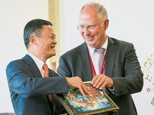  阿里巴巴創辦人馬雲（左）與俄羅斯直接投資基金總執行長奇呂，在簽約儀式后交換紀念品。