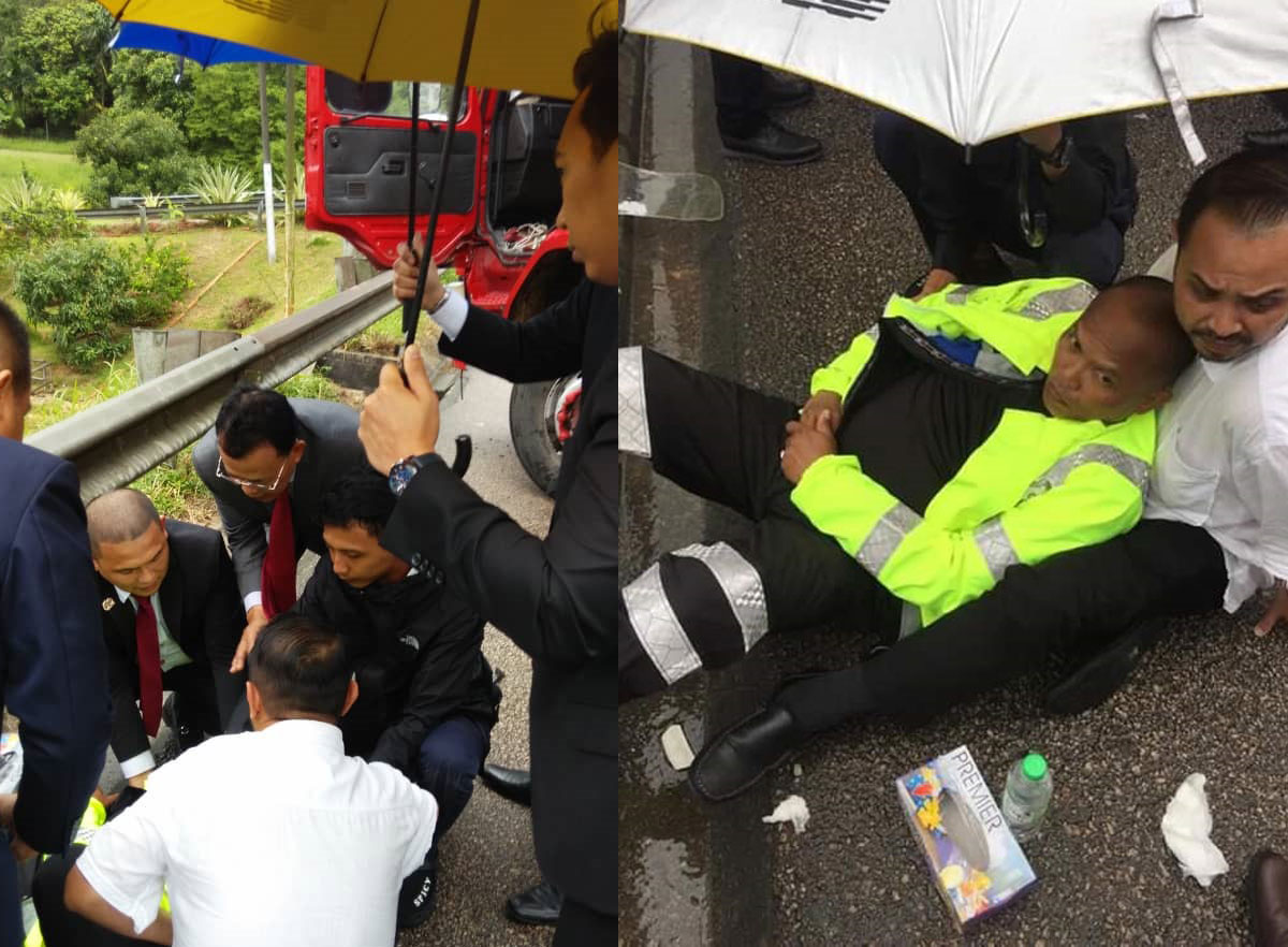 车祸发生后，众人不顾雨势皆下车施予援手，为受伤交警撑伞。