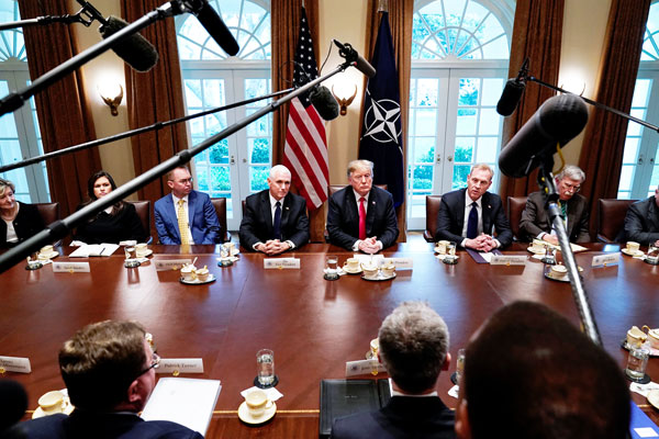 美国总统特朗普（右3）及副总统彭斯（左4）连同其行政团队，周二在白宫内阁室与北约秘书长斯托尔滕贝格会面。（路透社）