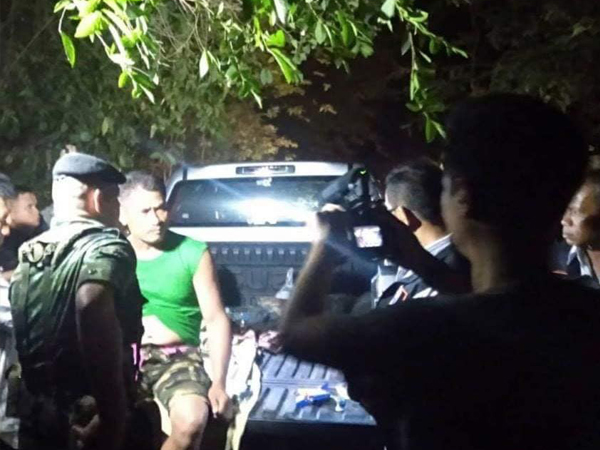 被捕的威奈（绿色T恤者）接受警方盘问。