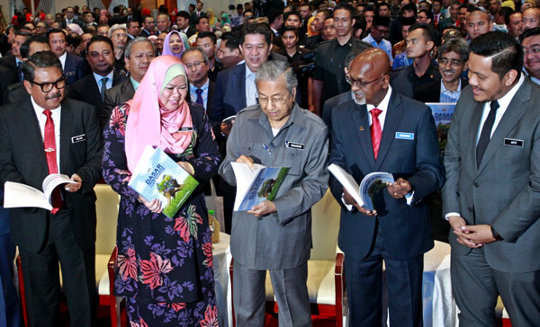 馬哈迪（中）翻閱鄉區發展政策的內容。左起是阿末再蘭尼、麗娜哈倫及西華拉沙。