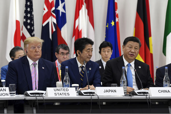 特朗普（前左）、日本首相安倍晋三（前中）及中国领导人习近平（前右）并肩而坐。