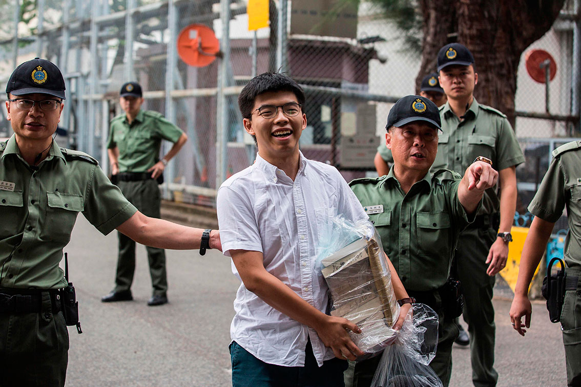 黄之锋（中）周一出狱，离开香港荔枝角收押所。（法新社）