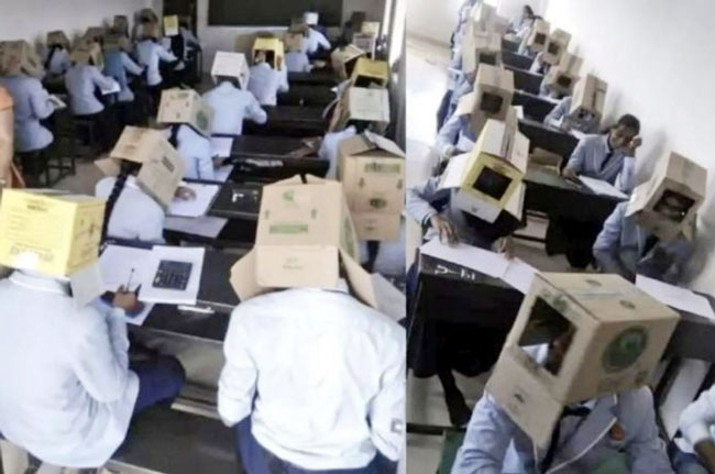 印度学生们头上戴着纸箱进行考试。