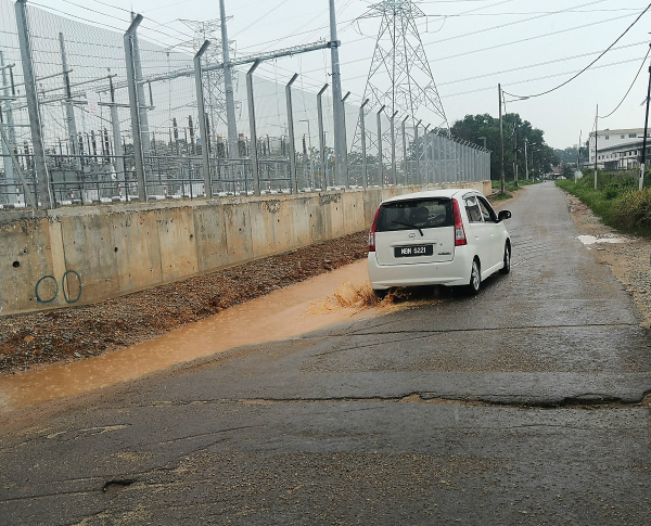 每当下雨时，路旁就积满泥浆水，车辆进出非常不方便。