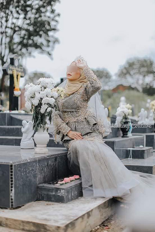 模特儿穿着婚纱坐在坟墓上搔首弄姿。