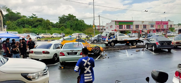 蓝色车辆（右）本来是罗惹摊的位置，而跑车则砸到不远处的泊车位上的两辆车。