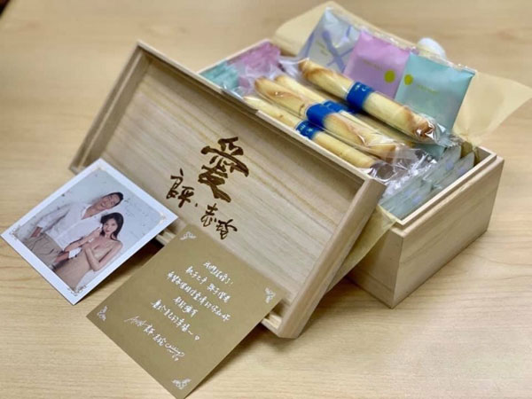 林志玲选购日本高档蛋卷礼盒YOKU MOKU为喜饼，并且订制木盒，刻上小俩口之名与林志玲父亲手写的“爱”字。