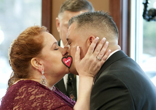 夫妻在婚礼中深情接吻。（美联社）