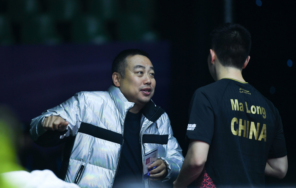刘国梁（左）在乒联总决赛期间指点马龙。（新华社）