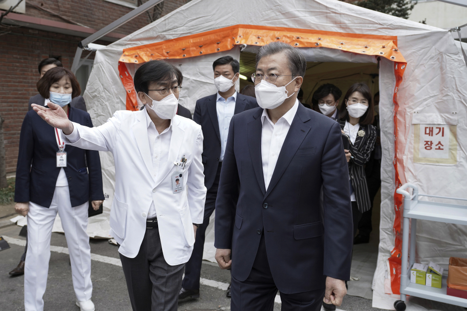 韩国总统文在寅（右）周二视察首尔的国立中央医院时戴上口罩。（美联社）