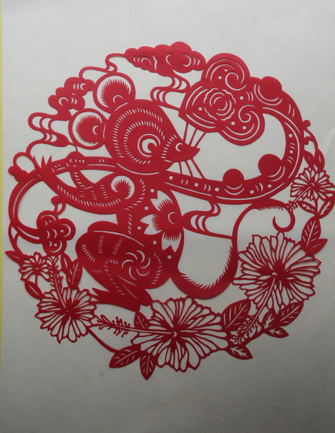 图中的作品是老鼠手持如意，并有马来西亚大红花衬托，象征如意吉祥，团团圆圆。