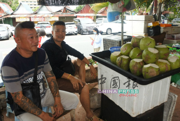 姚氏（左起）与黄氏以折价出售水果。