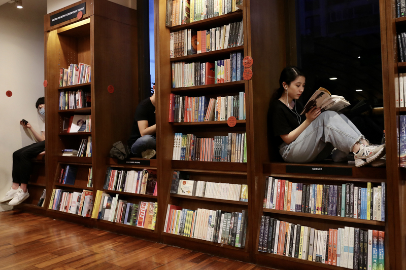 诚品敦南店31日熄灯，不少民众在最后一天的凌晨前往书店，坐在窗台享受阅读乐趣。（中央社）