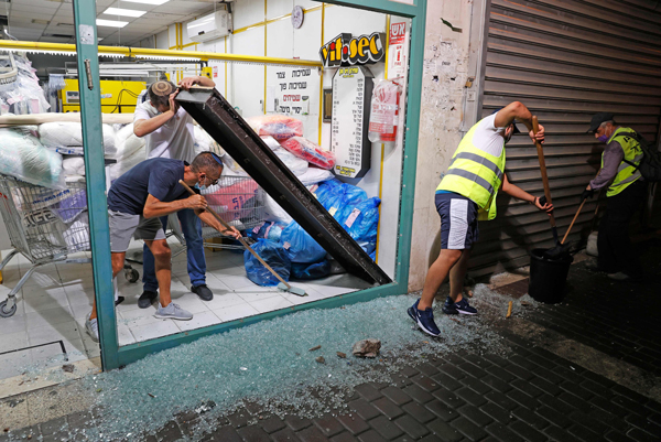 阿什杜德一家洗衣店周二晚遭到火箭弹波及，门店玻璃破碎。（法新社）