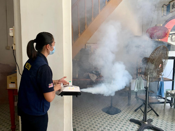 义工到鸡场街沿路的同乡会馆进行免费消毒喷雾工作。
