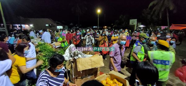 前来领取免费蔬菜的公众都有秩序的等待工作人员把蔬菜排好。