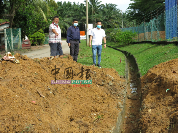 承包商已经将涵管挖起，蔡求伟（右起）、林千宏及汤开烈到场视察情况。