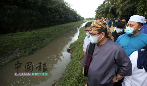 首长苏莱曼（左）视察双溪本俄巴雅乐浪河水受污染的情况。