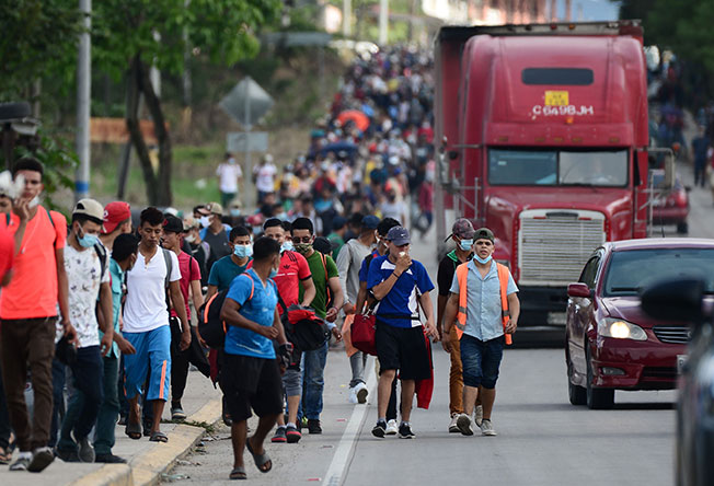 大批移民周五从洪都拉斯科潘省拉恩特拉达步行到危地马拉边境城镇，藉此路段在越境美国。（法新社）