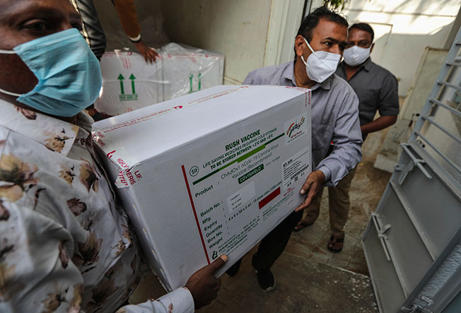 医护人员将装有疫苗的箱子送到医院。（美联社）