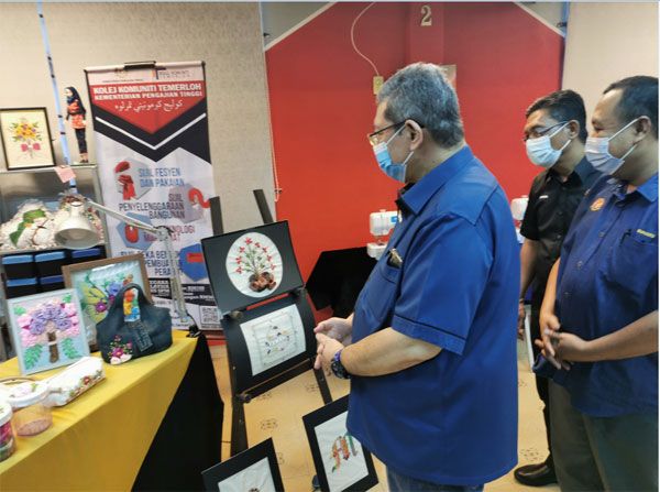 赛夫丁(左)受邀巡视淡马鲁技术学院创意产业的作品。