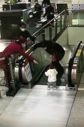 郭庆福跳到正在运行的手扶电梯台阶上，然后大步跨上电梯踏板。
