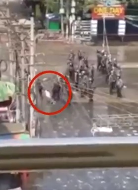 军人处决示威者后，把尸体拖走（红圈示）。