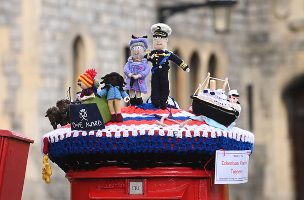 英国温莎堡的一个红色邮筒上，套着菲利普亲王和英女王伊丽莎白二世的绒毛装饰品，向菲利普亲王致敬。（欧新社）