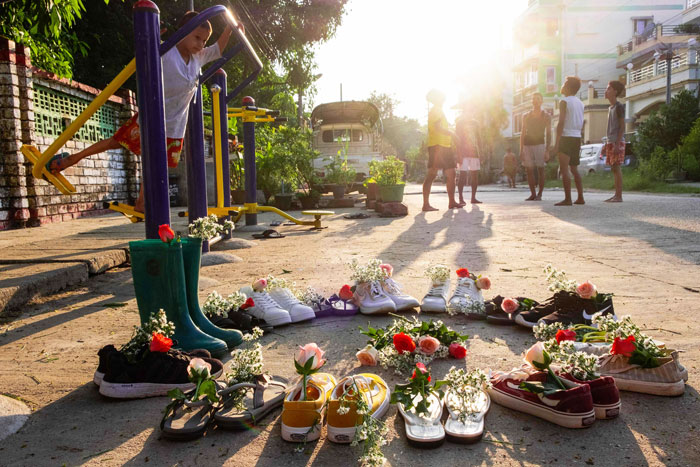 仰光宫古根镇一条街道摆放了鲜花鞋子，是“游行鞋罢工”的一部分，呼吁社交媒体反抗军权。（法新社）