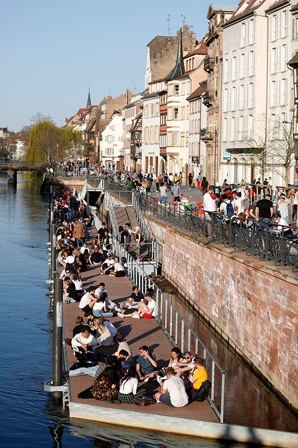 法国东部斯特拉斯堡河岸31日有许多青年聚集，没有社交距离。（美联社）