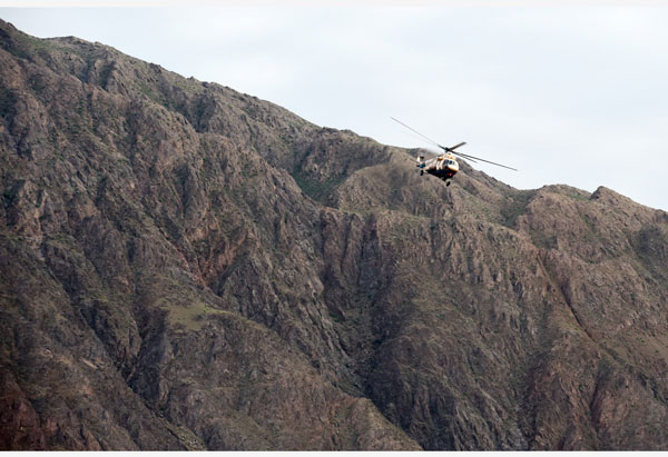 直升机在事发区域搜救失联人员。（新华社）
