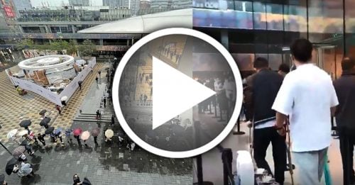 北京市民冒雨带伤 排队抢购iPhone 13