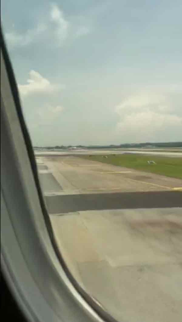 Alex Svanevik拍摄飞机窗外画面，显示航班已进入新加坡的机场跑道。
