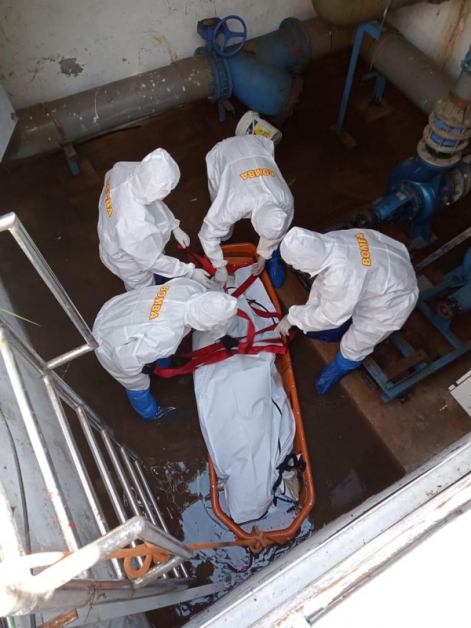 消拯员穿着完整的防护衣，深入泵房里把死者遗体取出。（消拯局提供）