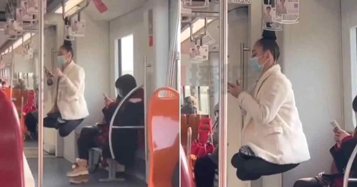 上海一名女乘客头发吊手把，悬空晃荡搭地铁。