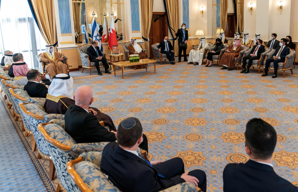 以色列总理贝内特（中西装者）和巴林王储兼首相萨勒曼及双方代表团15日在古戴比亚宫会面。（法新社）