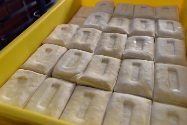 邹生制作的传统硬豆腐，长方形，中间凹陷的外形辨识度高。硬豆腐做好后涂抹少量盐，并用风扇吹凉后，即可存放在冷藏库，涂抹盐可以杀菌，让豆腐更耐放。