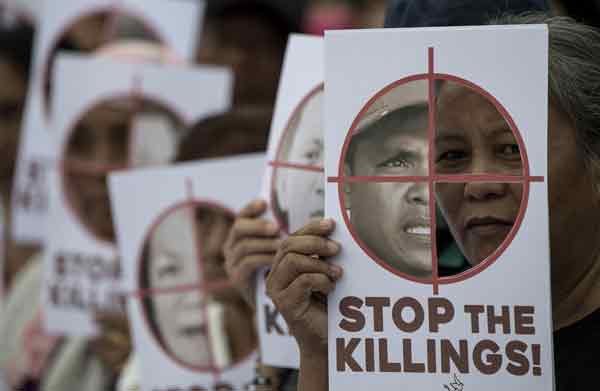 2017年12月10日国际人权日，示威者在马尼拉举起标语，抗议迪泰特政府的血腥扫毒作风。（法新社）