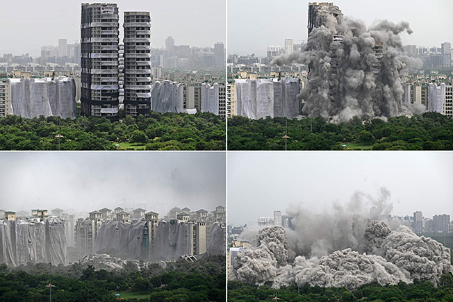 新德里两栋未完成的高楼，28日由当局爆破炸毁。（法新社）