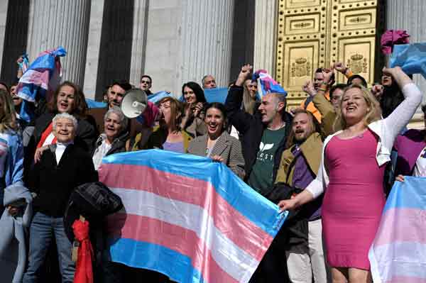 西班牙平等部长蒙特罗（中）周四在国会外与跨性别社运份子等一起庆祝跨性别法案和带薪月经假的法案成功通过。（法新社）